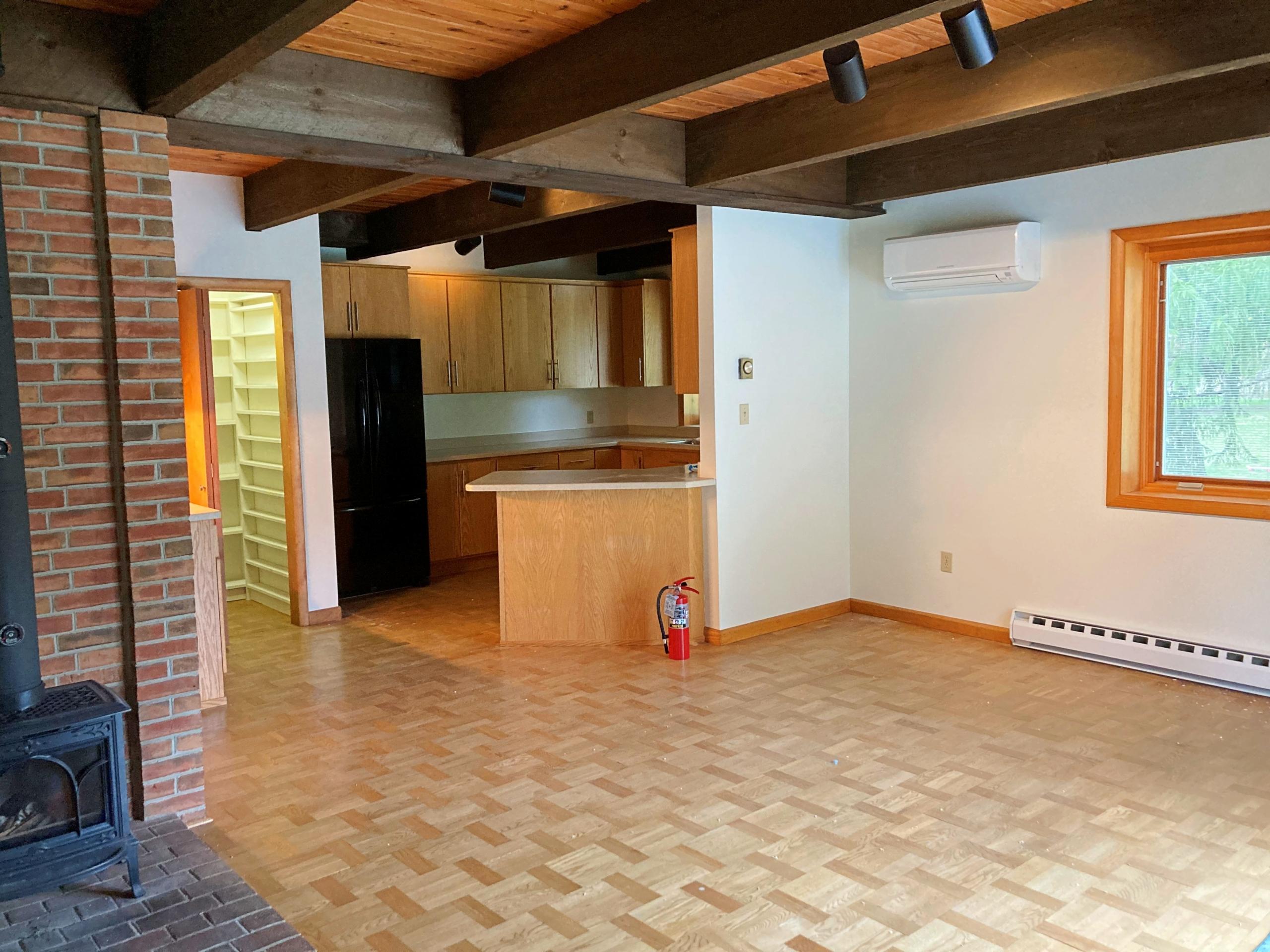 Open concept living area with kitchen and fireplace
