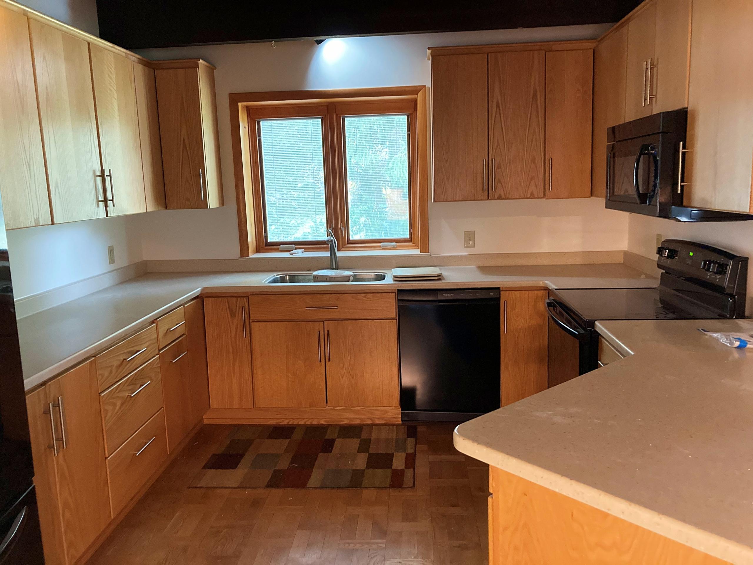 Kitchen with wood cabinets and window