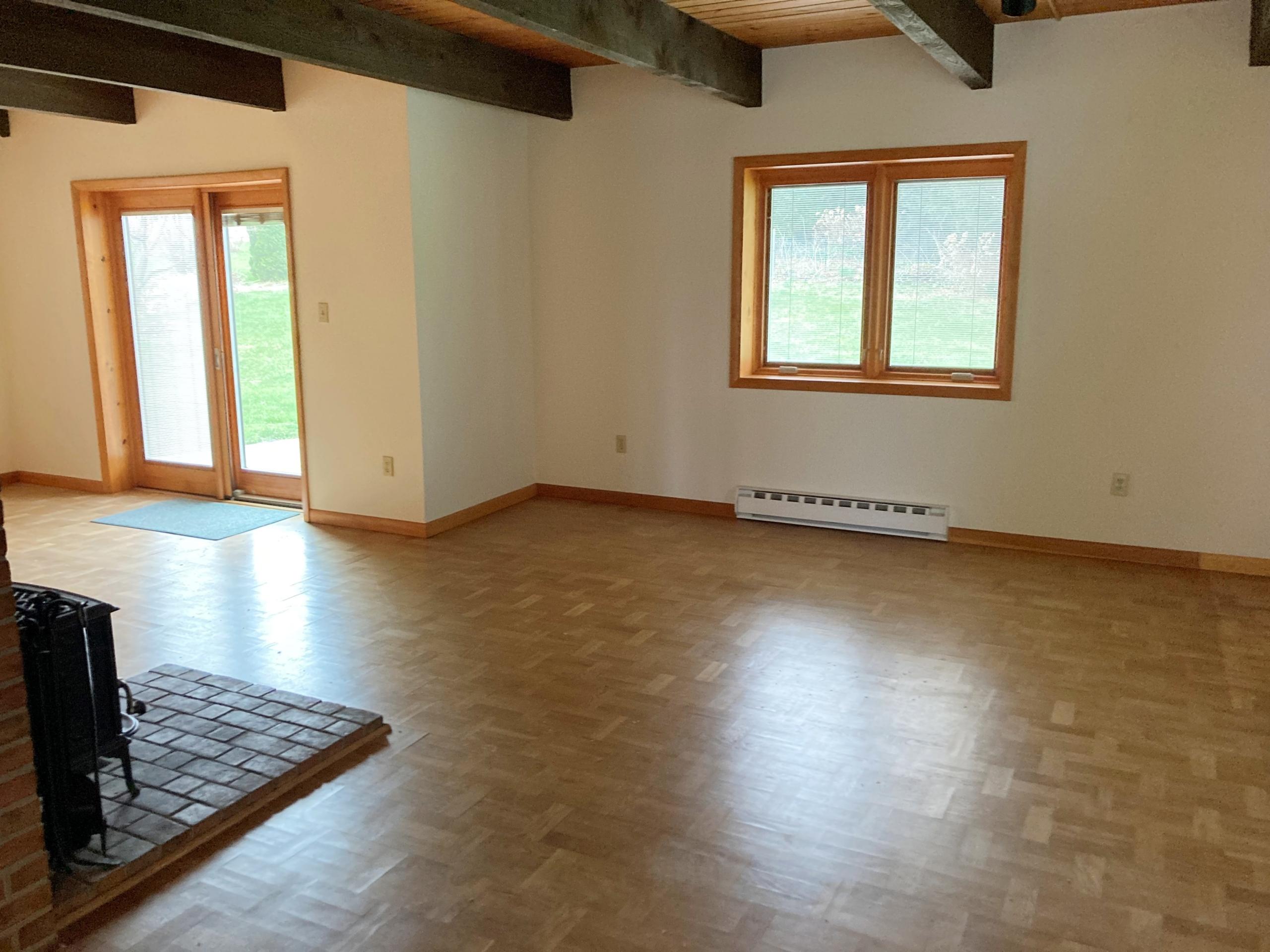Empty living room with wood floor and window