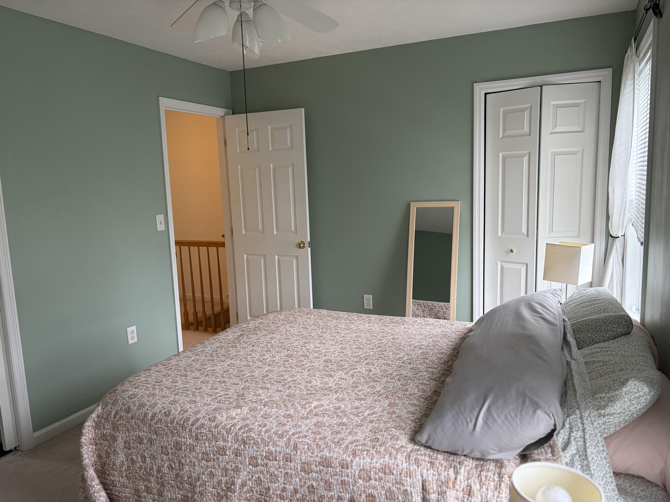 Bedroom with bed, closet, and door