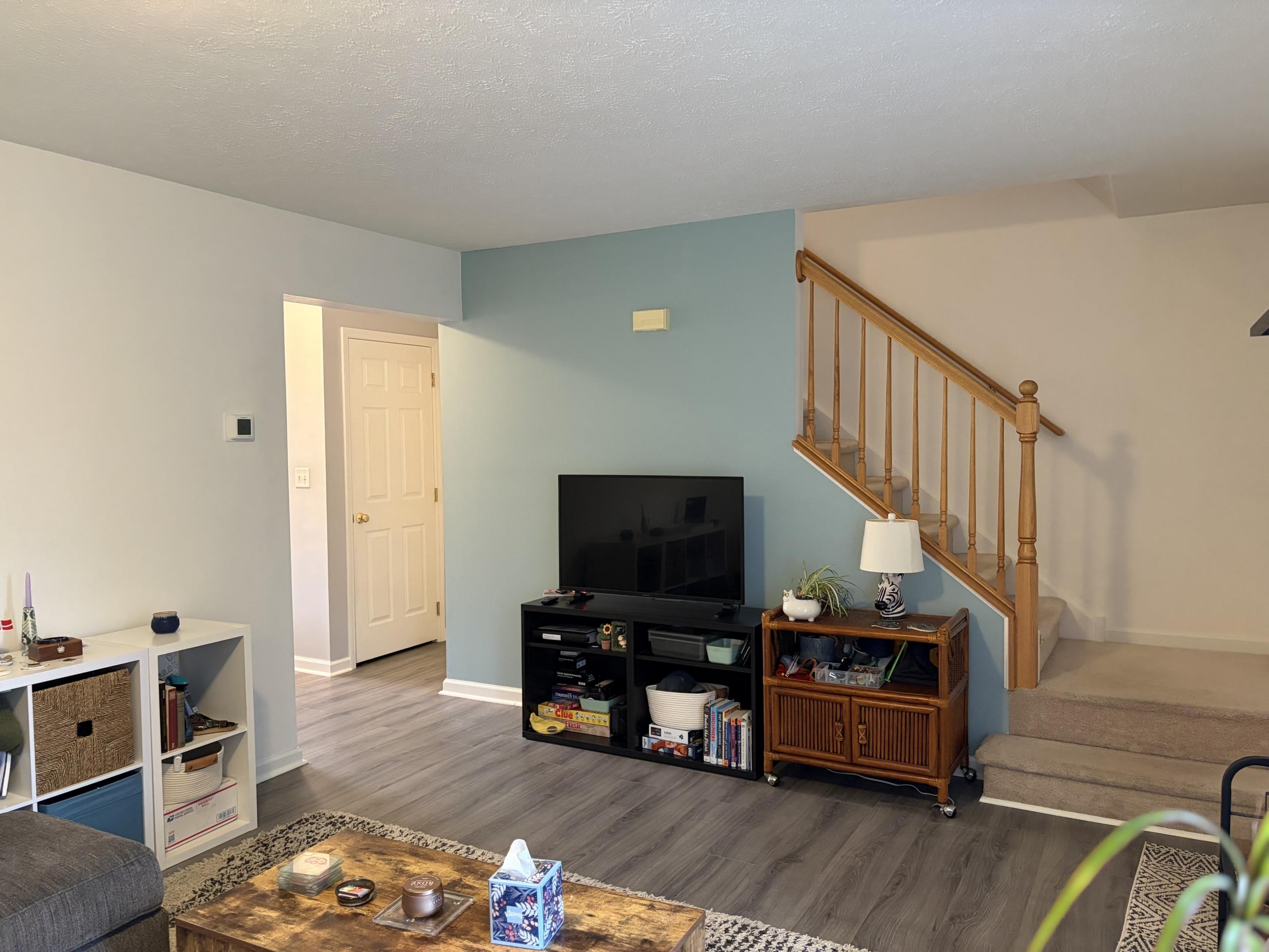 Living room with TV and stairs