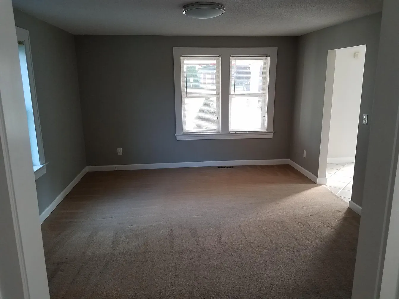 Empty living room with beige carpet