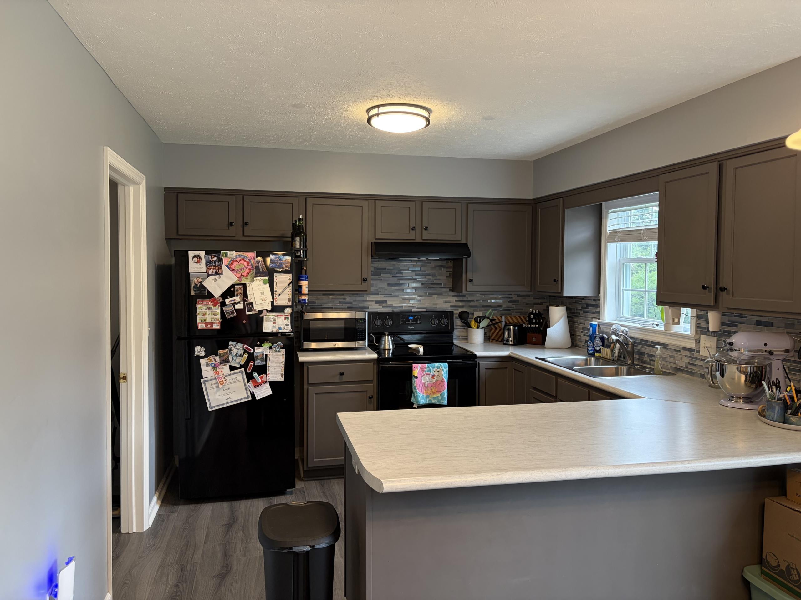 Modern kitchen with dark gray cabinets.