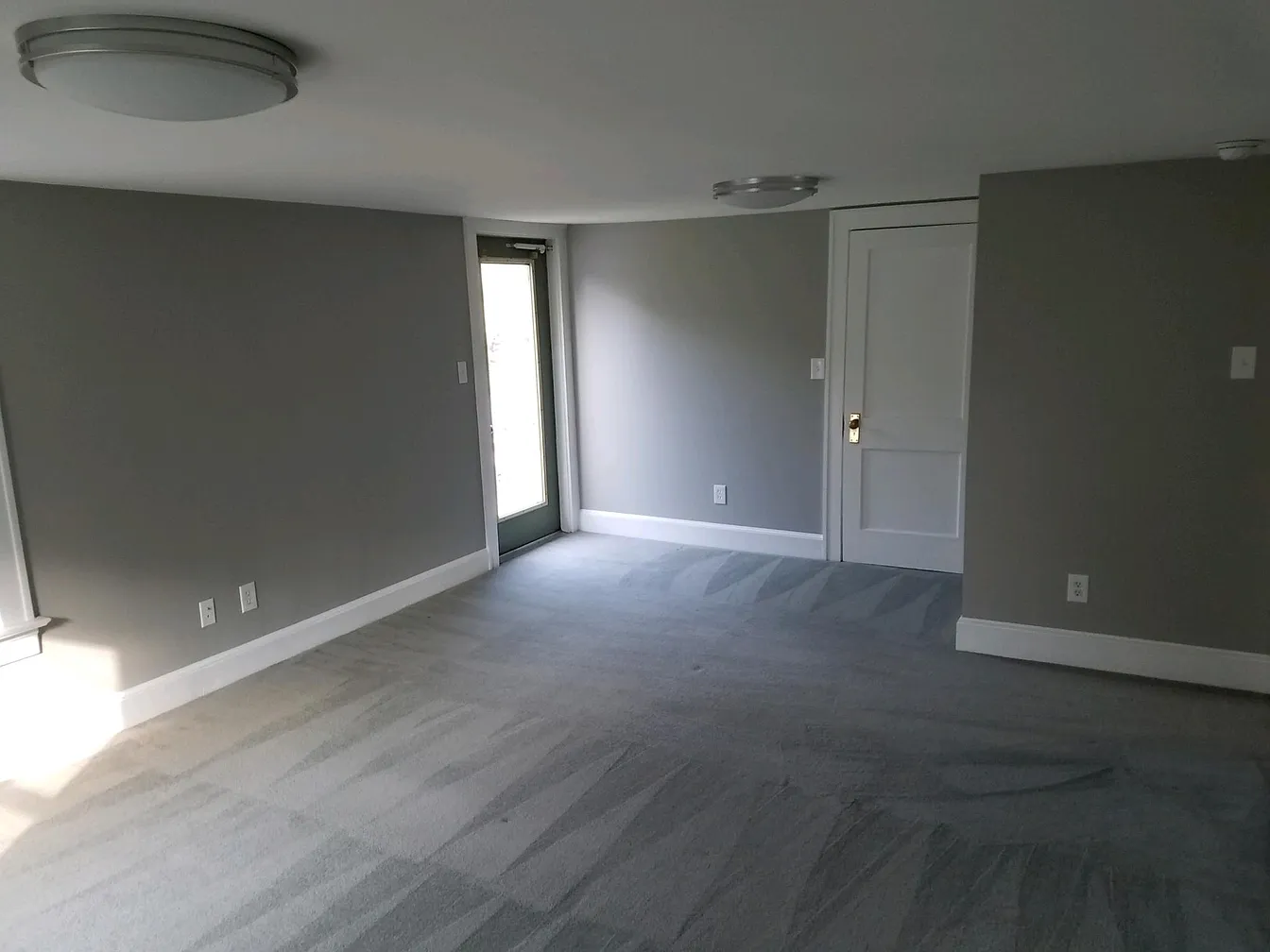Empty bedroom with gray walls and carpet