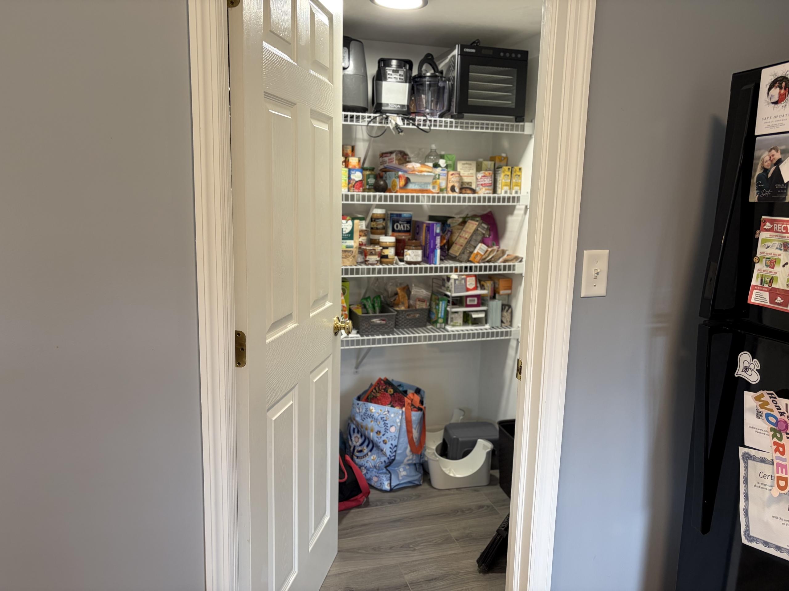 Pantry with shelves of food and appliances