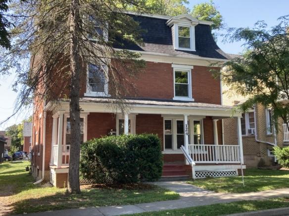Red brick Victorian house with porch