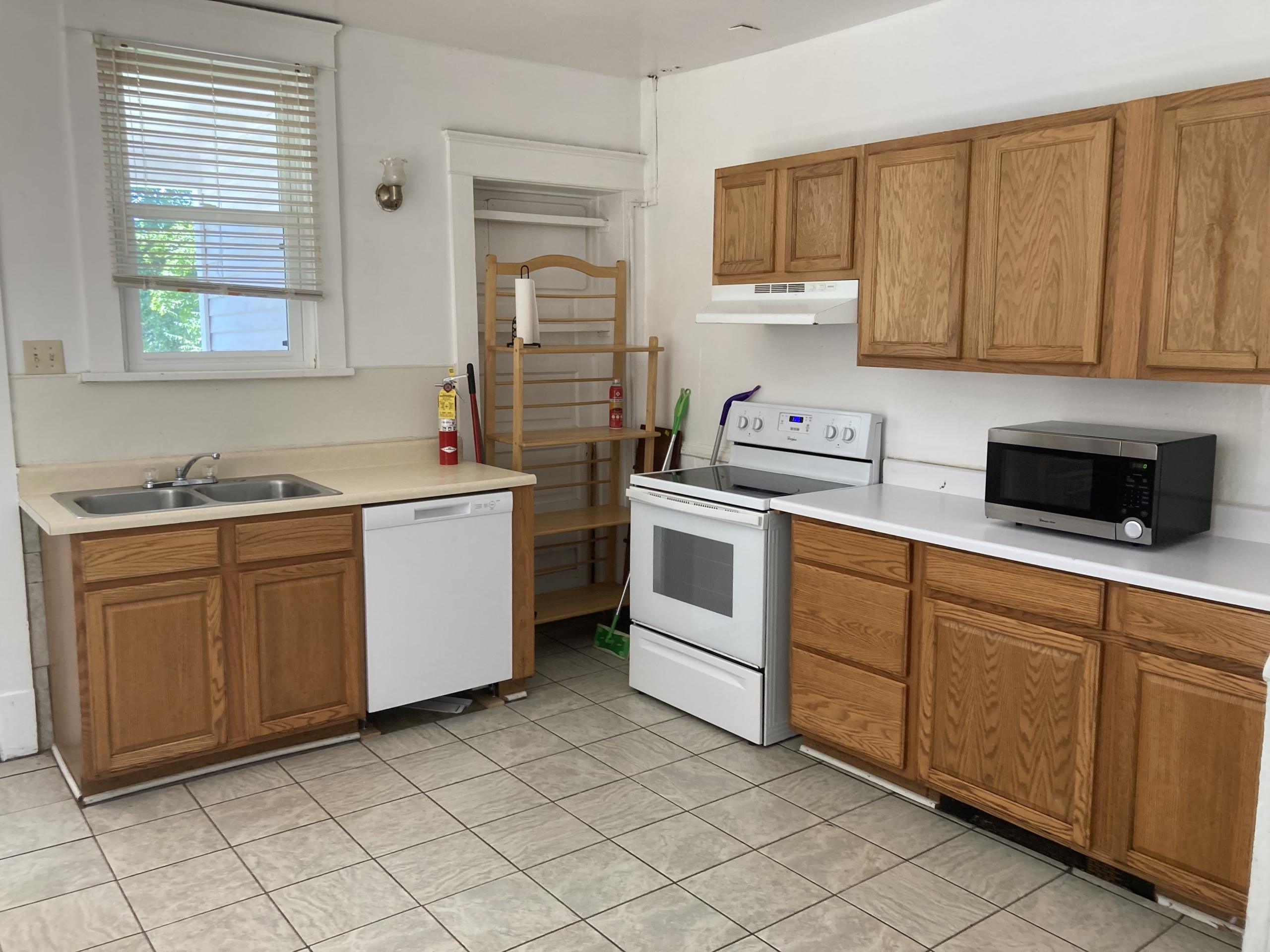 Kitchen with wooden cabinets and appliances