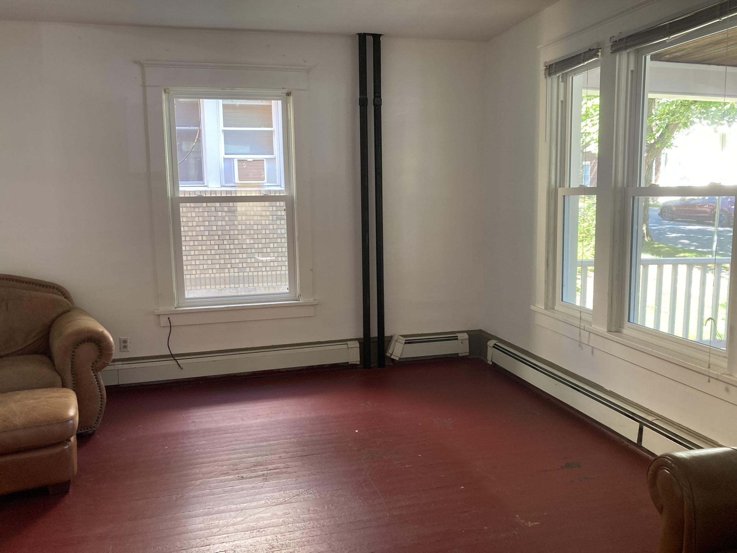 Empty room with red floor and windows