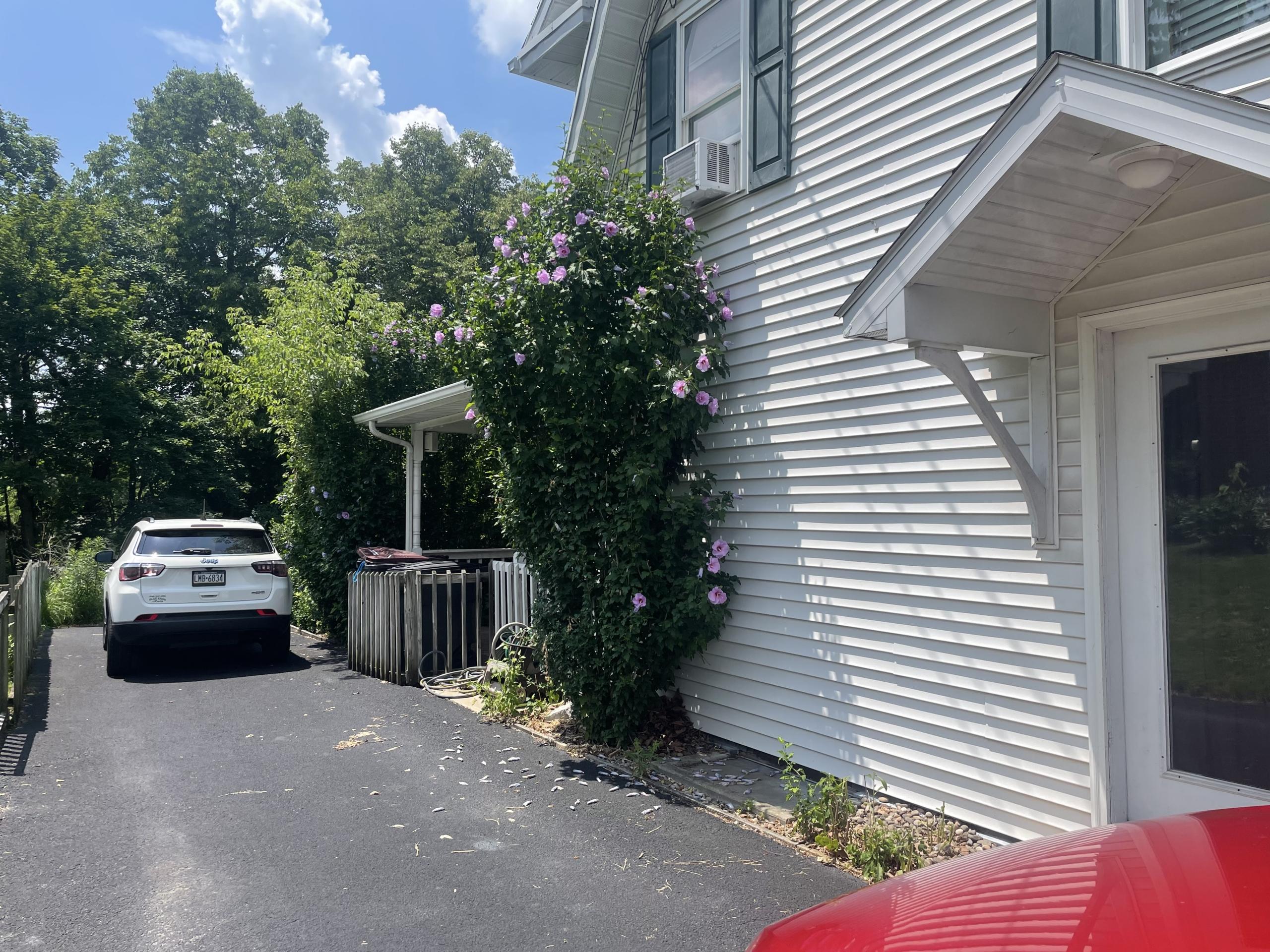 White SUV parked on driveway near house