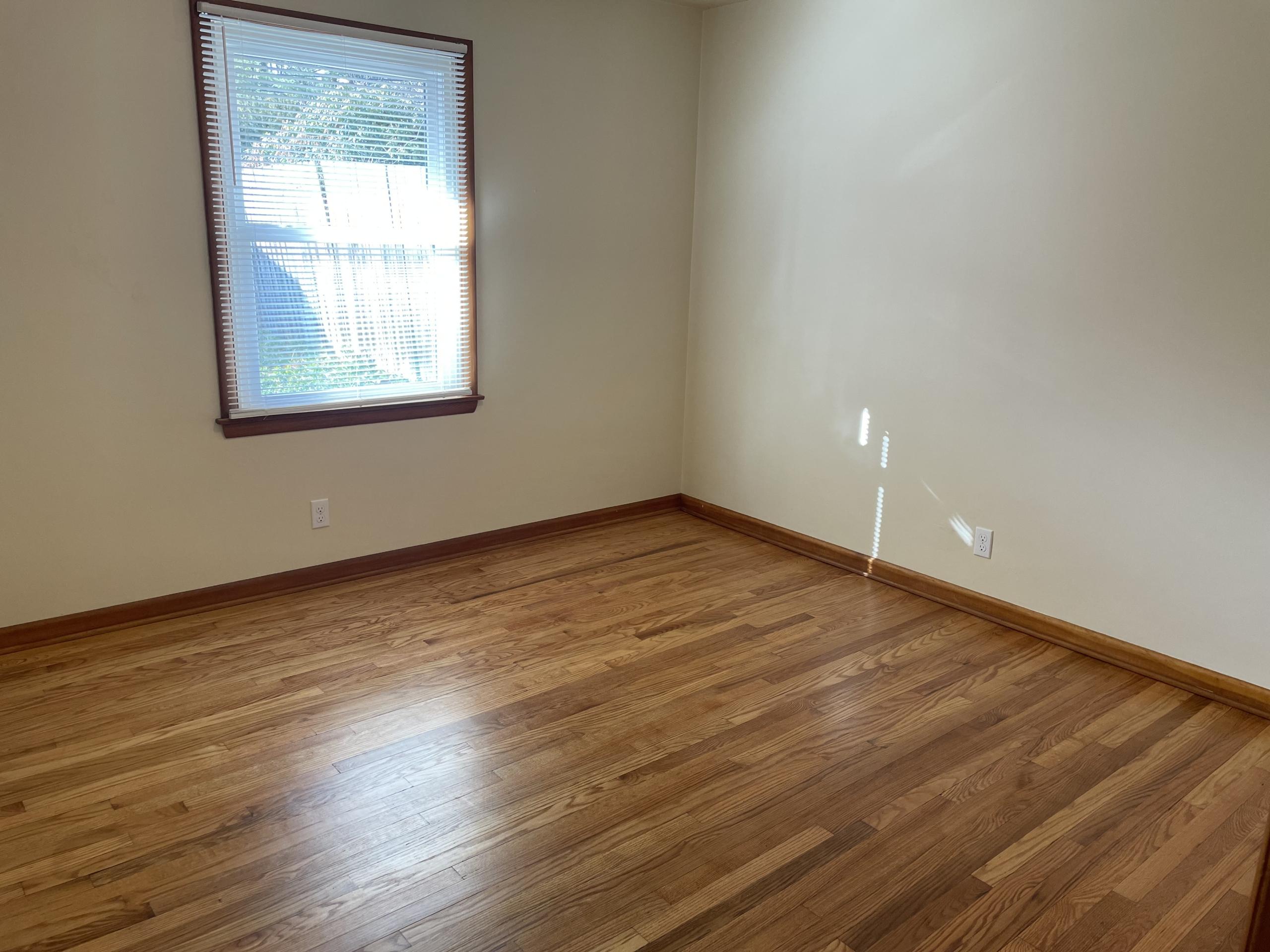 Empty room with hardwood floors and window