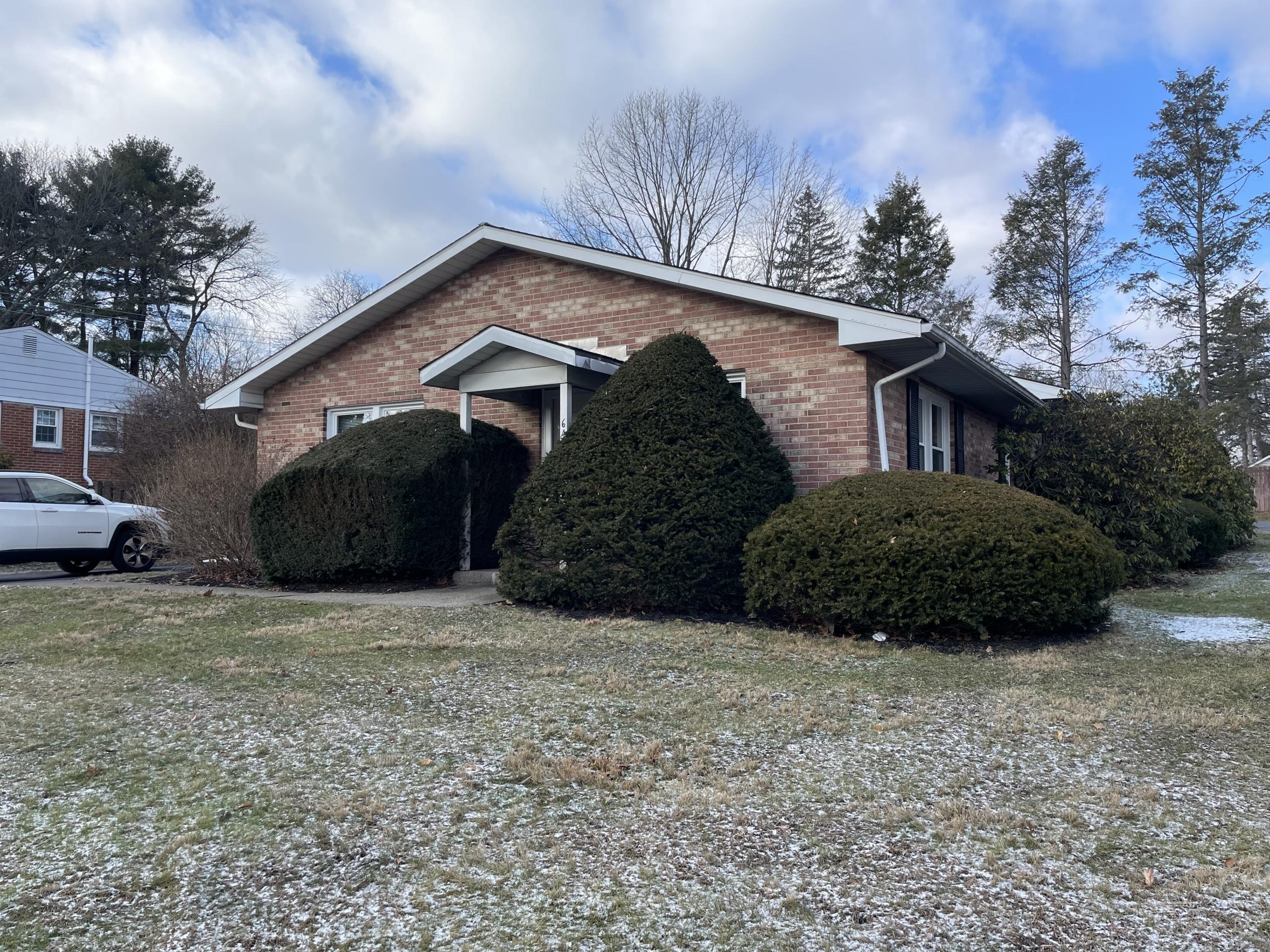 Brick ranch house with snow