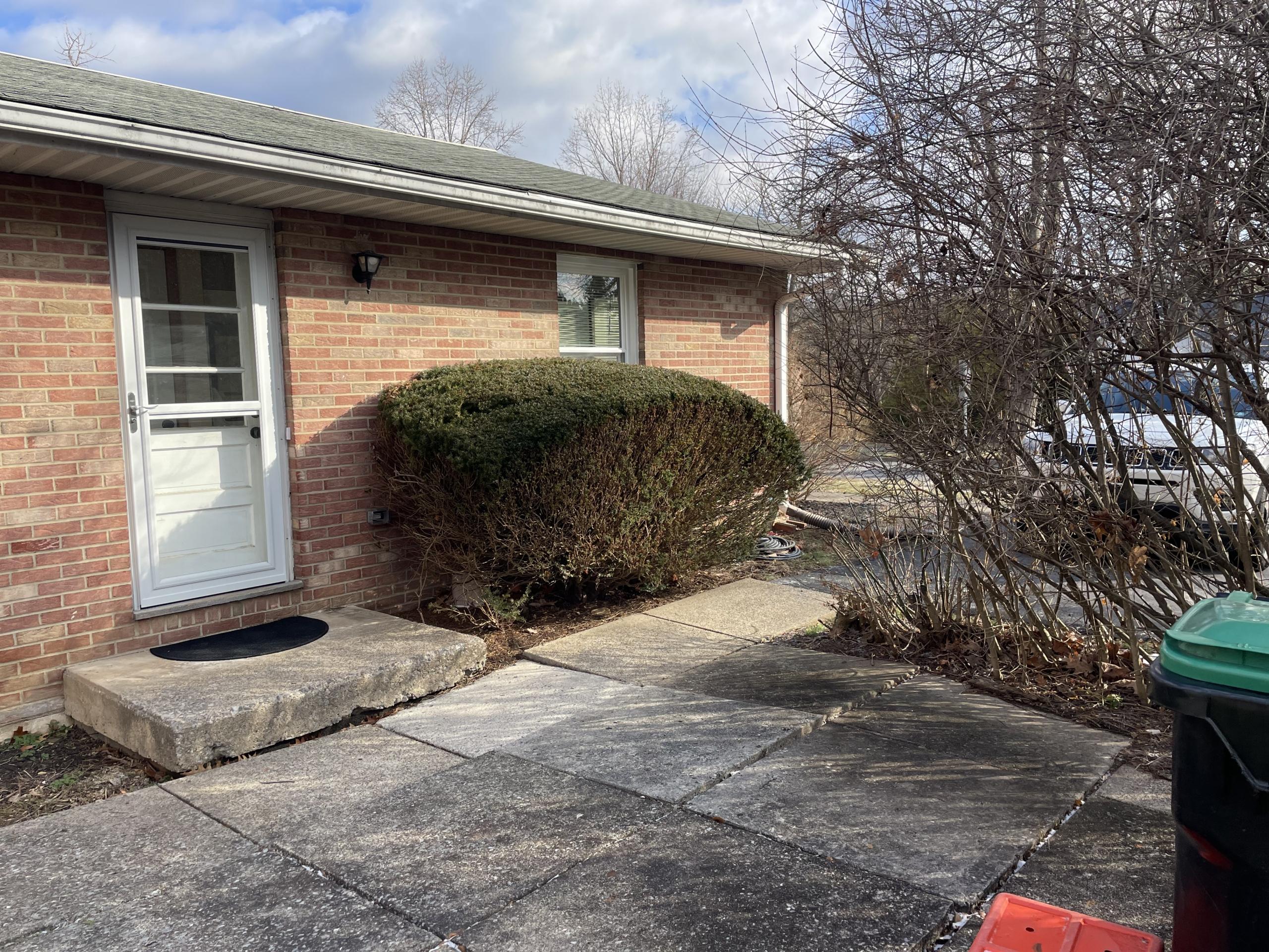 Brick building exterior with a white door