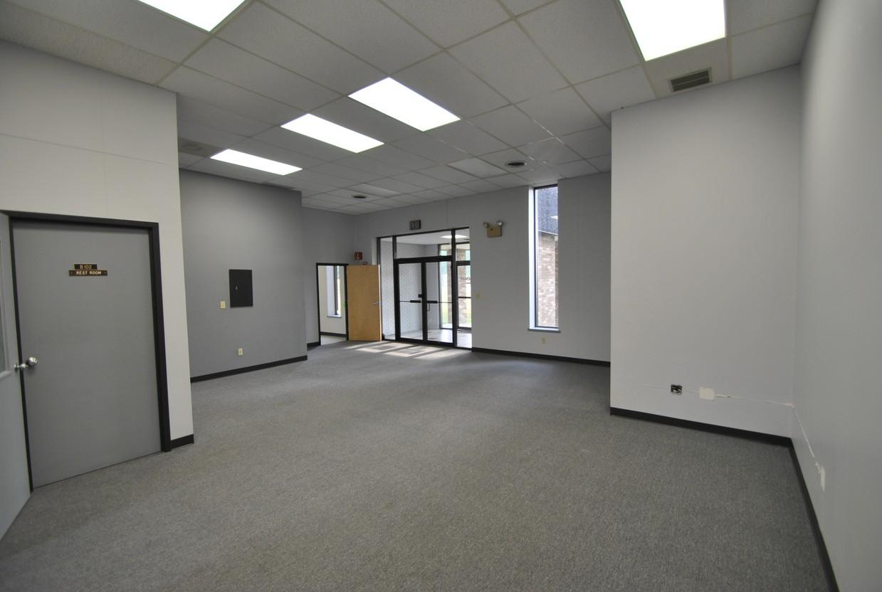 Empty office space with gray walls and carpet