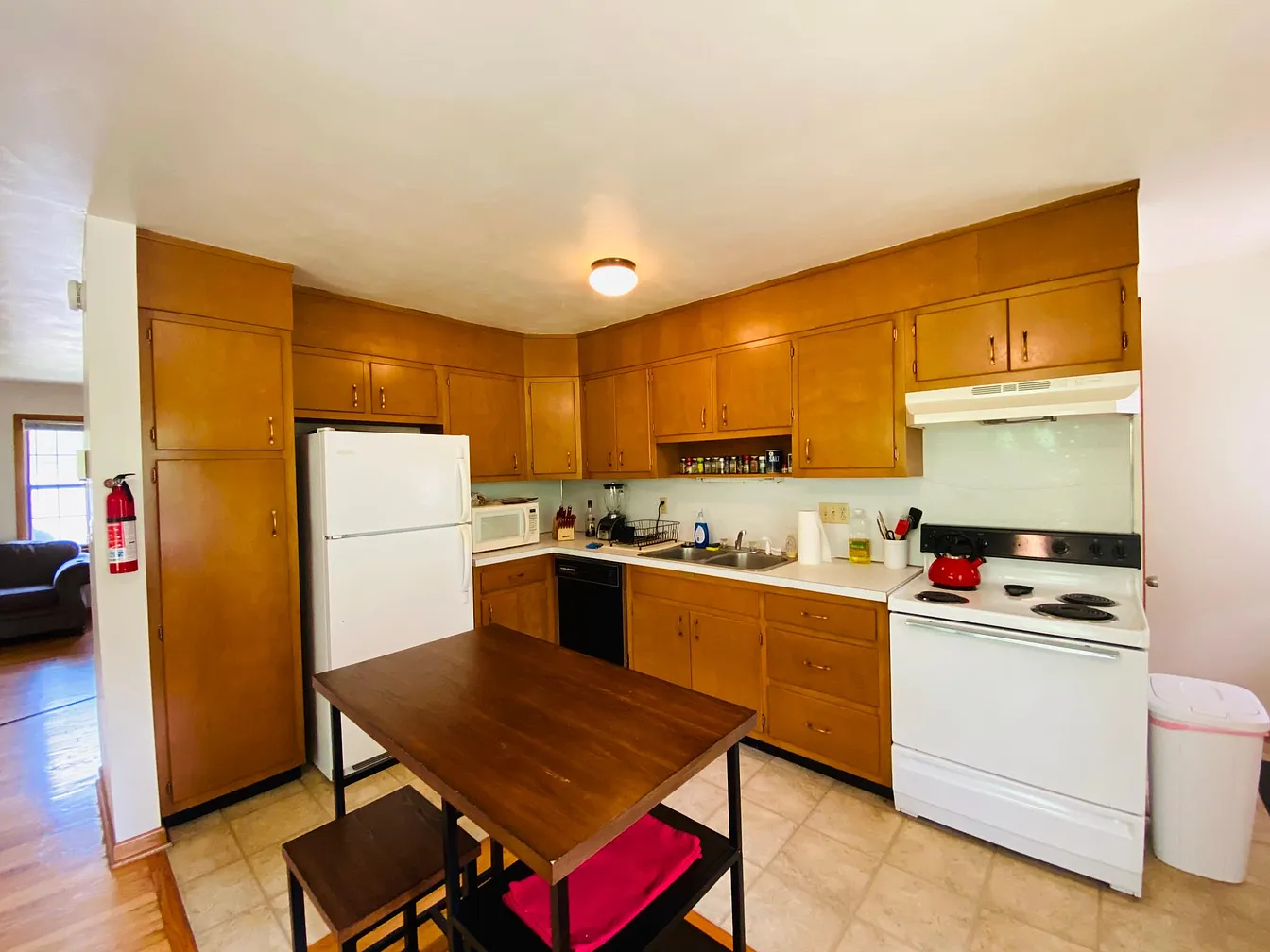 Kitchen with wood cabinets and white appliances