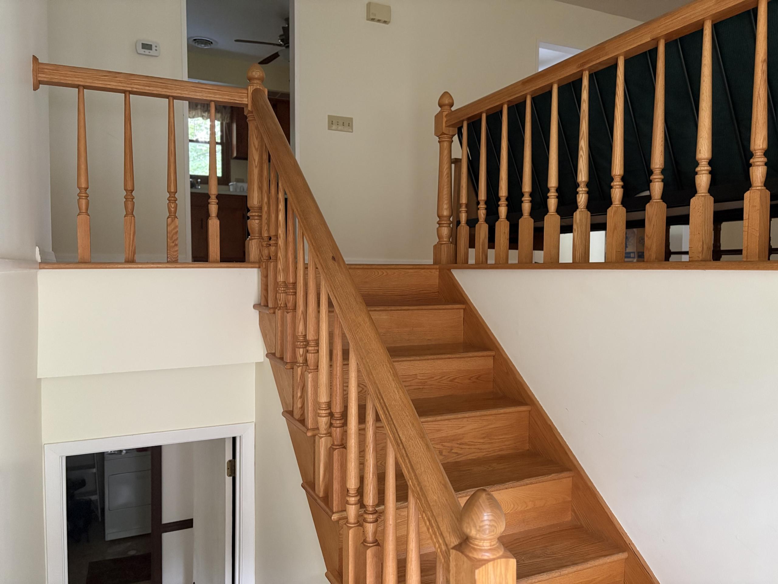 Wooden staircase with railing in home