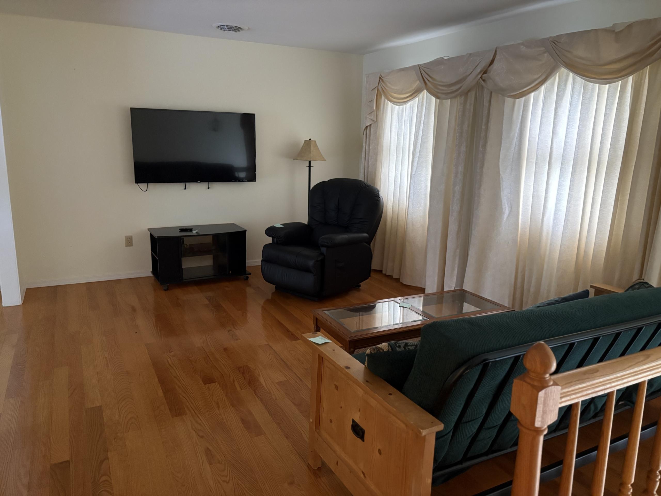 Living room with sofa, recliner, and TV