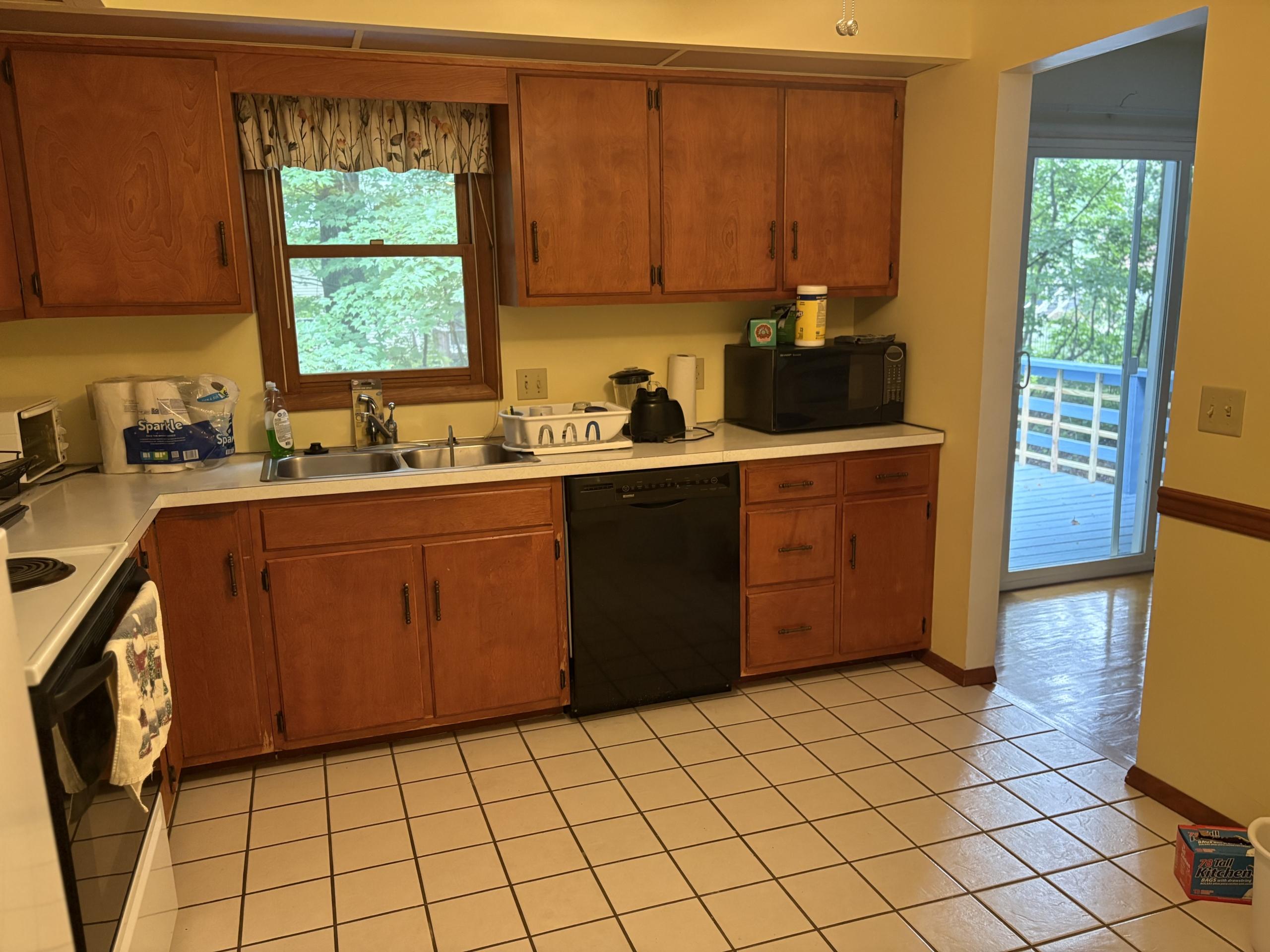 Kitchen with wood cabinets and yellow walls