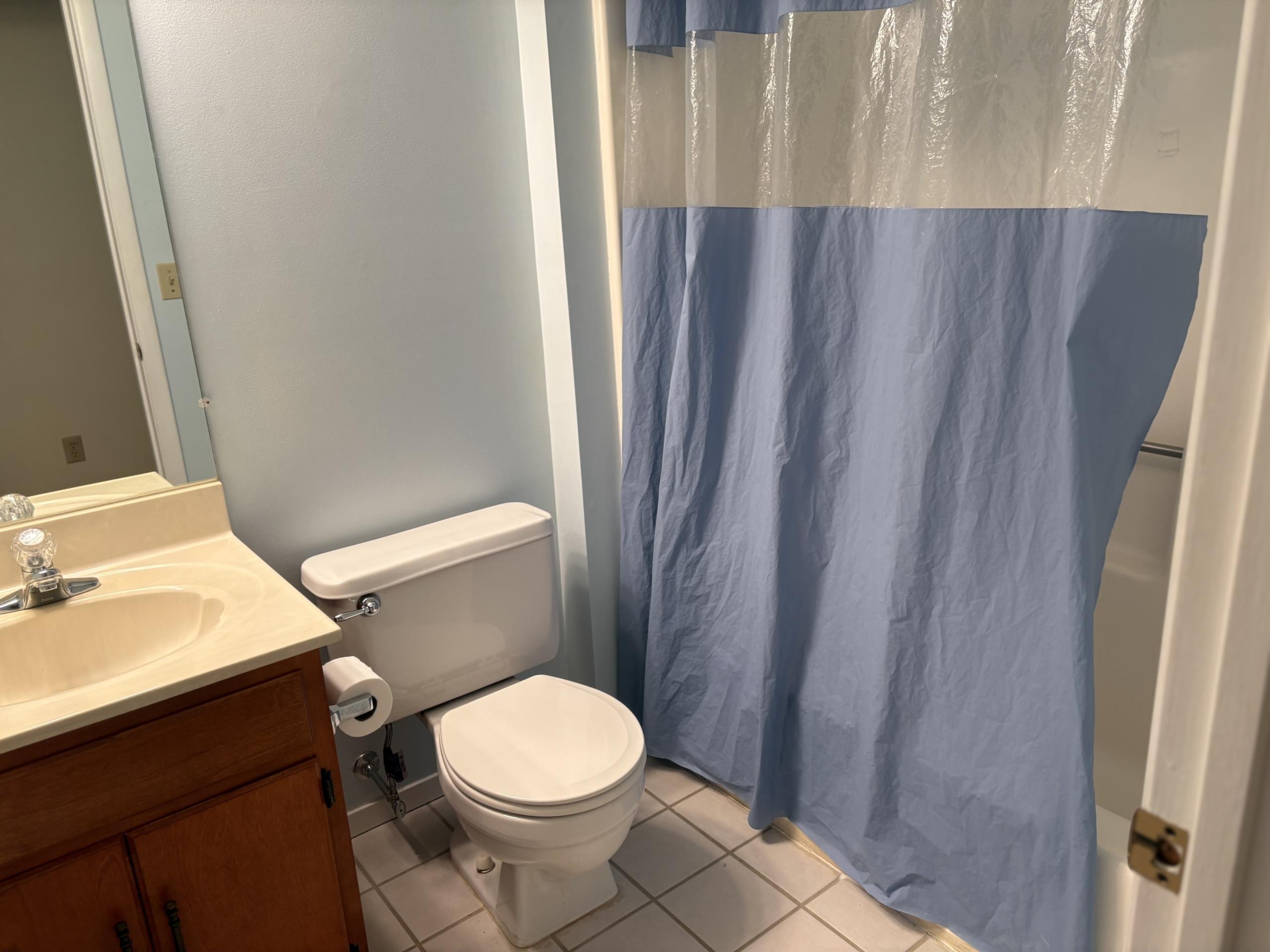 Bathroom with toilet and shower curtain