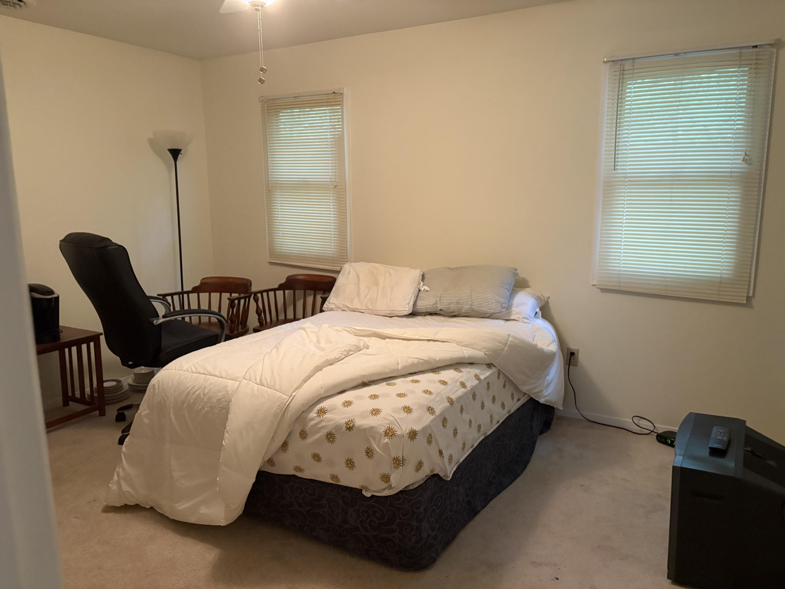 Bedroom with bed, desk, and chairs