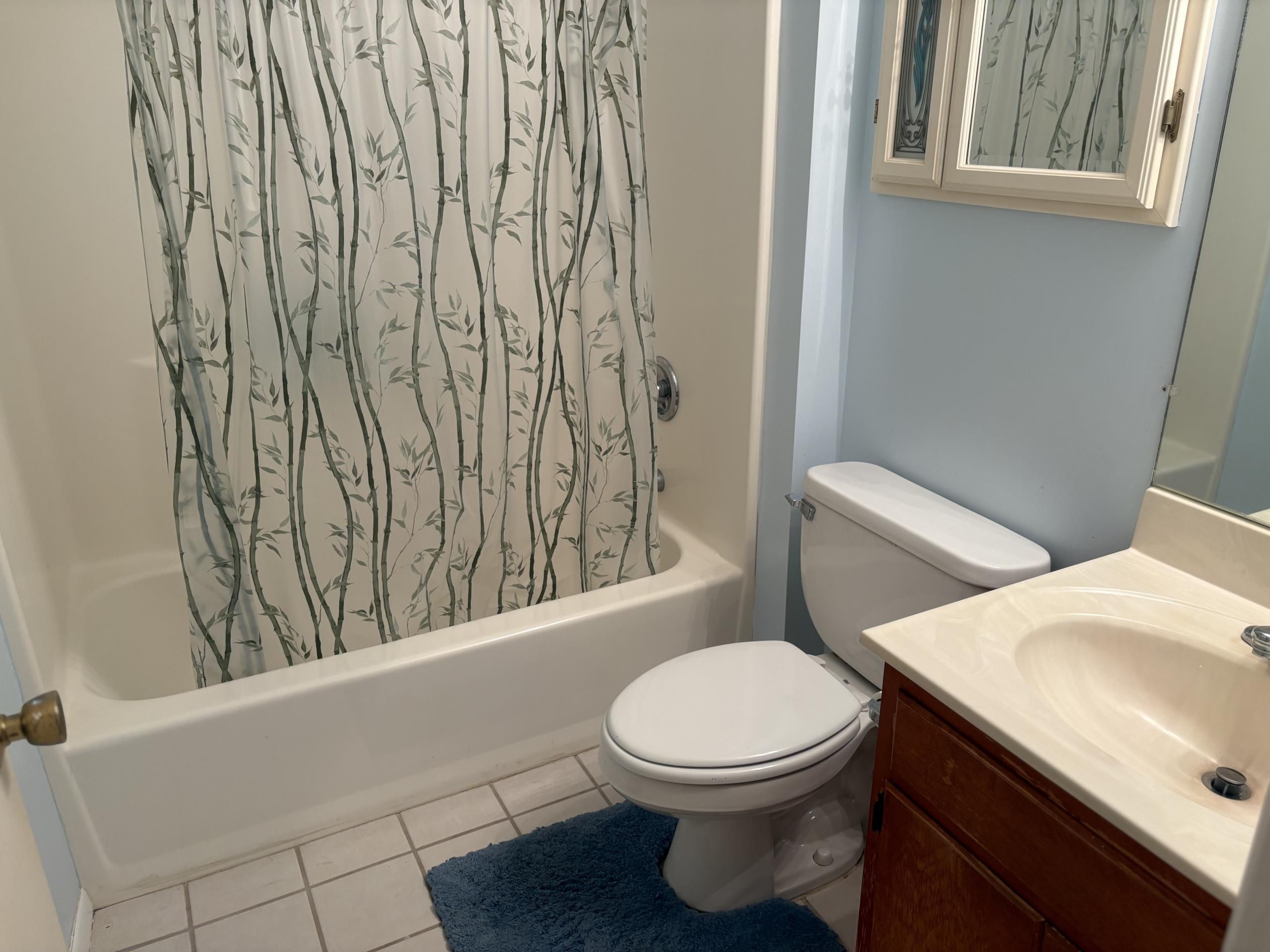 Bathroom with tub, toilet, and vanity