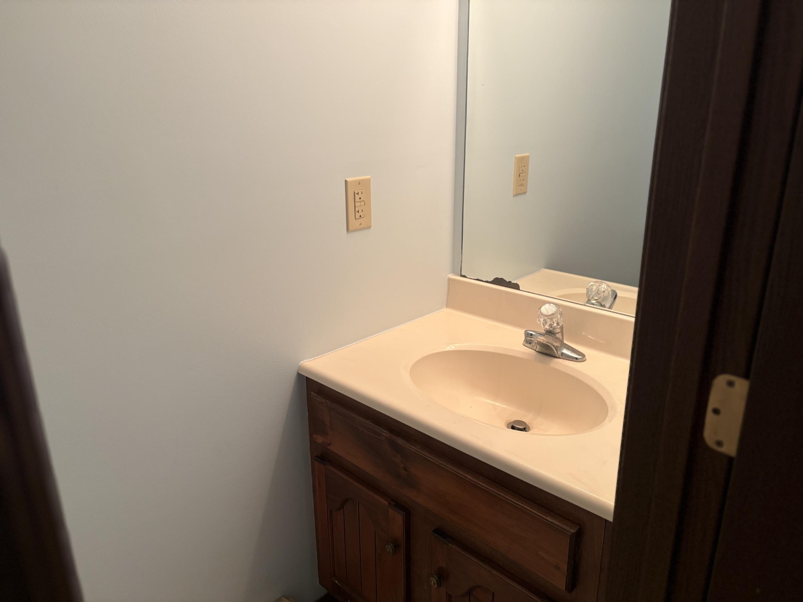 Bathroom vanity with sink and mirror