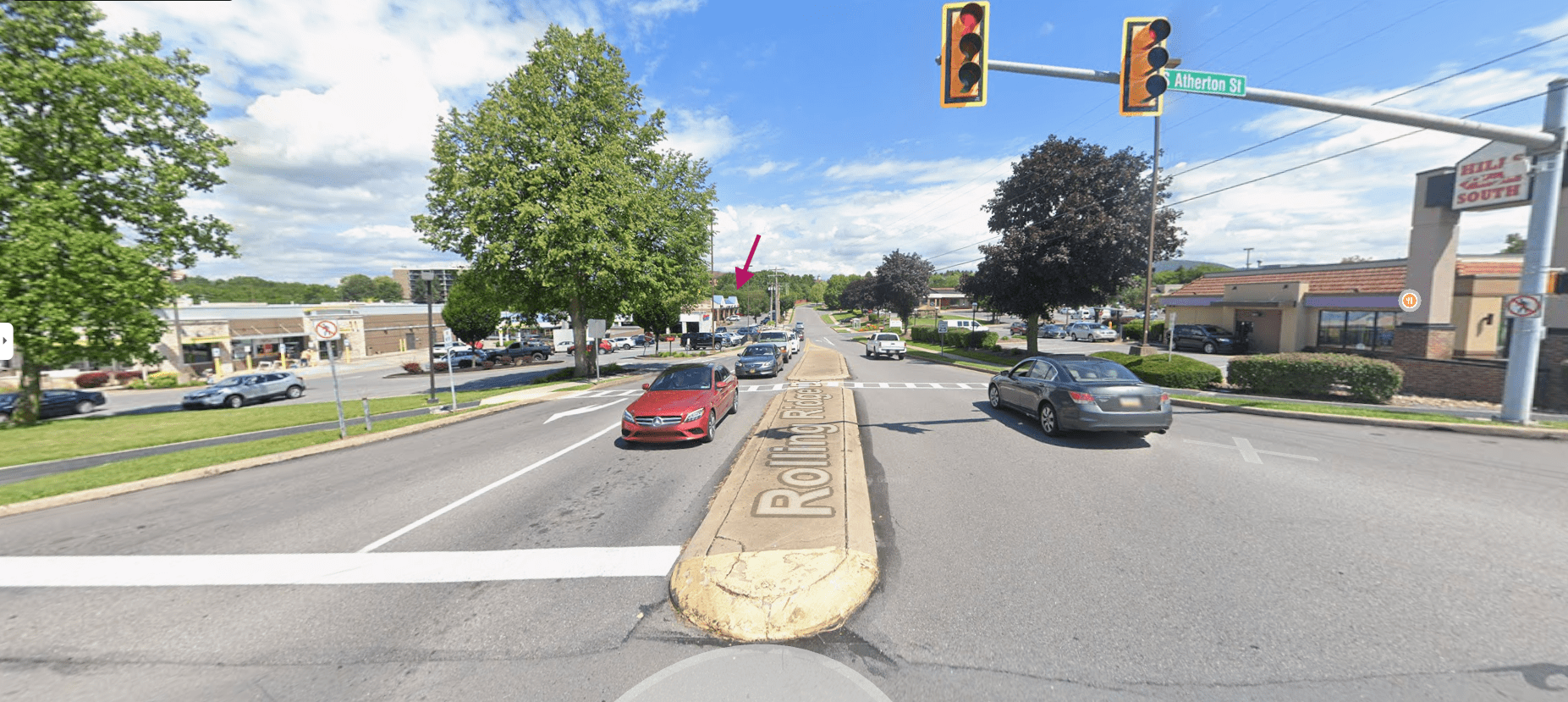 Red car at intersection with Rolling Ridge sign