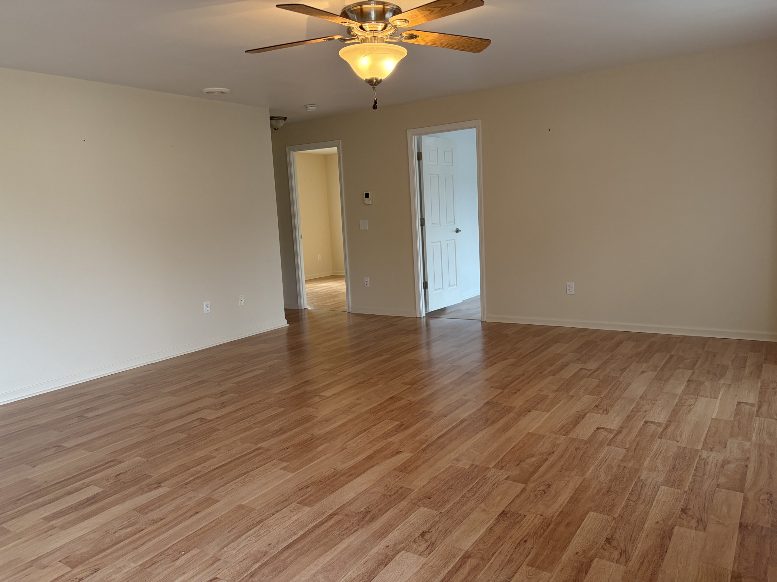 Empty living room with wood floors