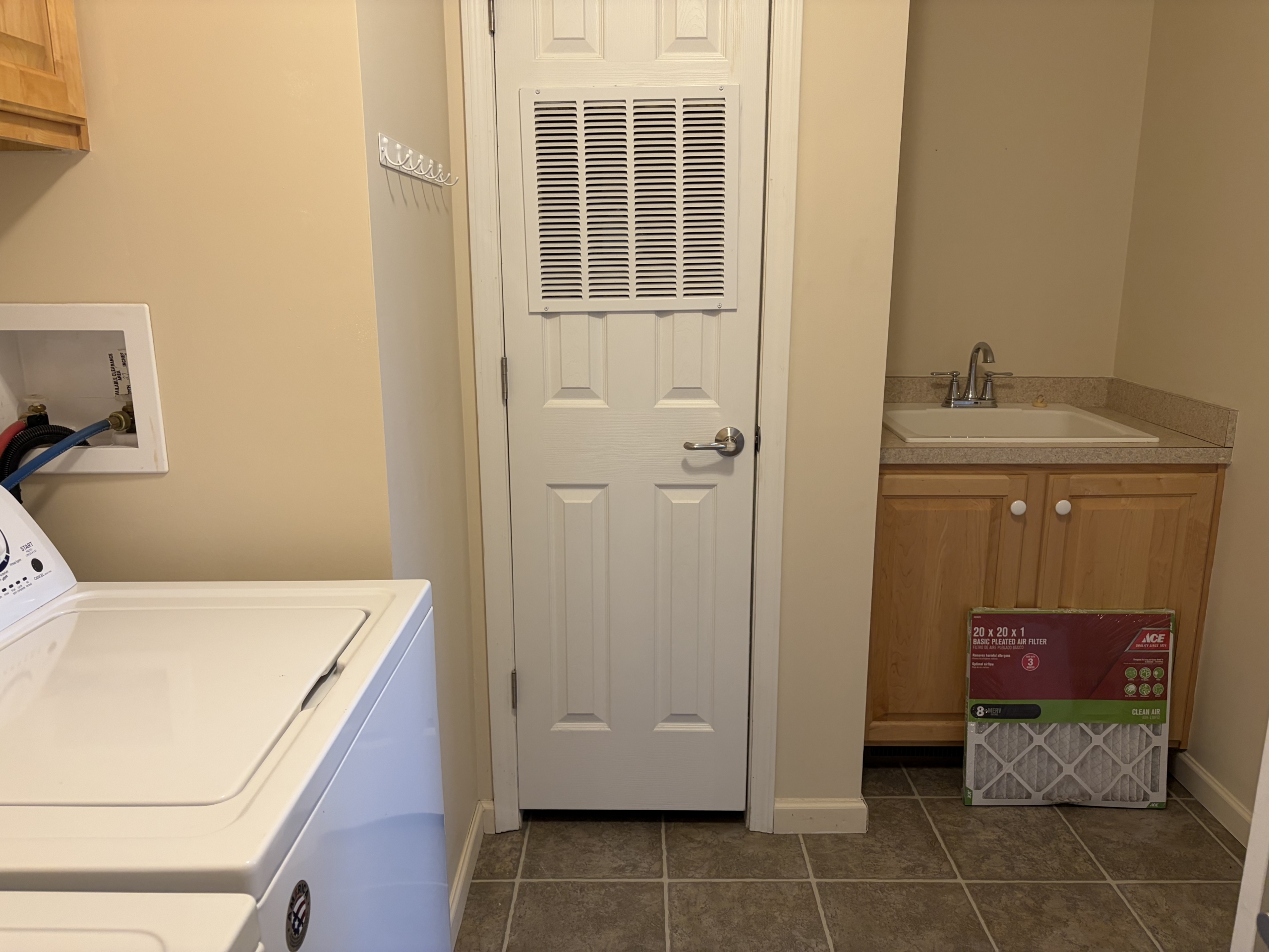 Laundry room with washer, dryer, and sink