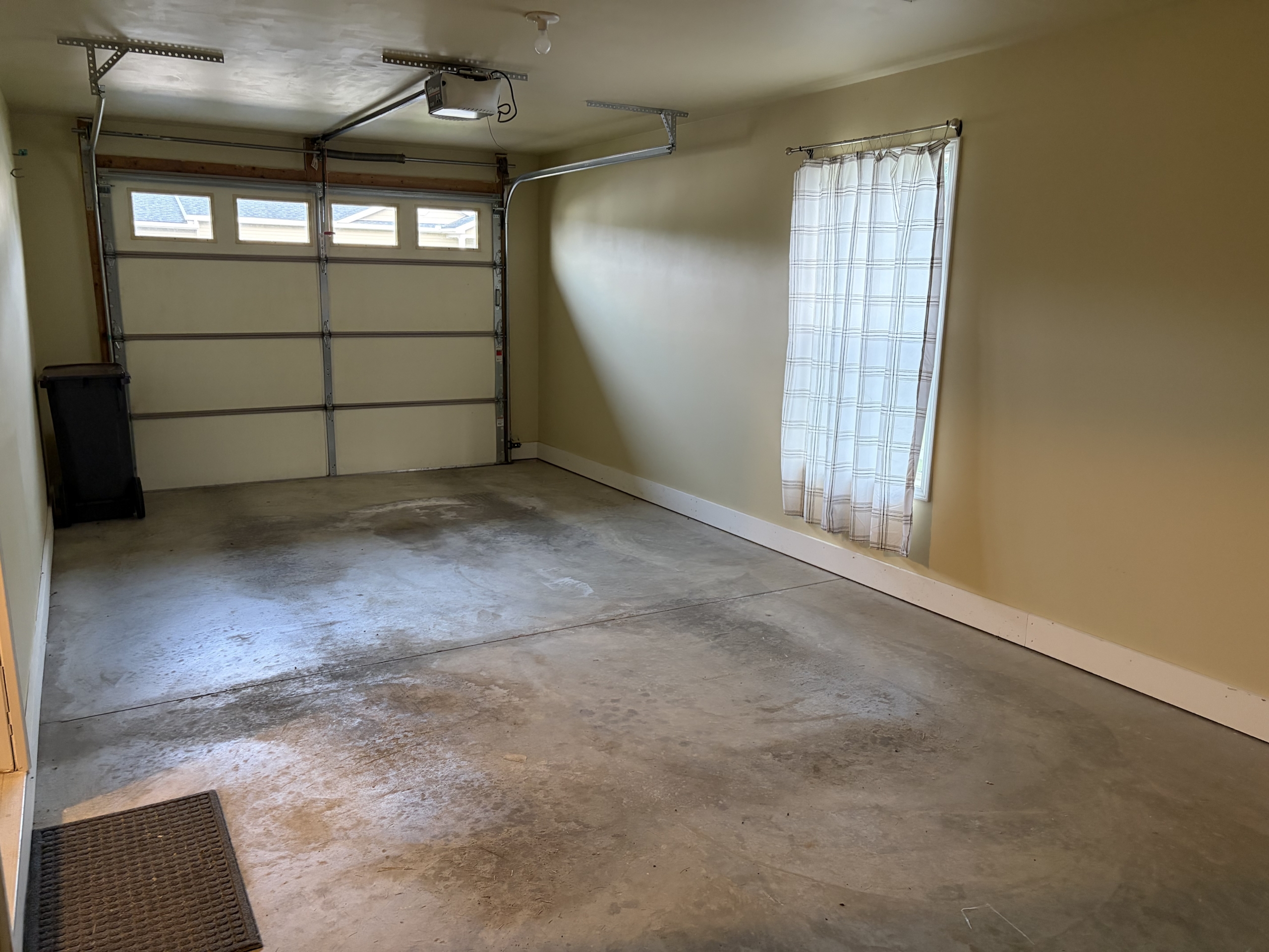 Empty garage with open door and window