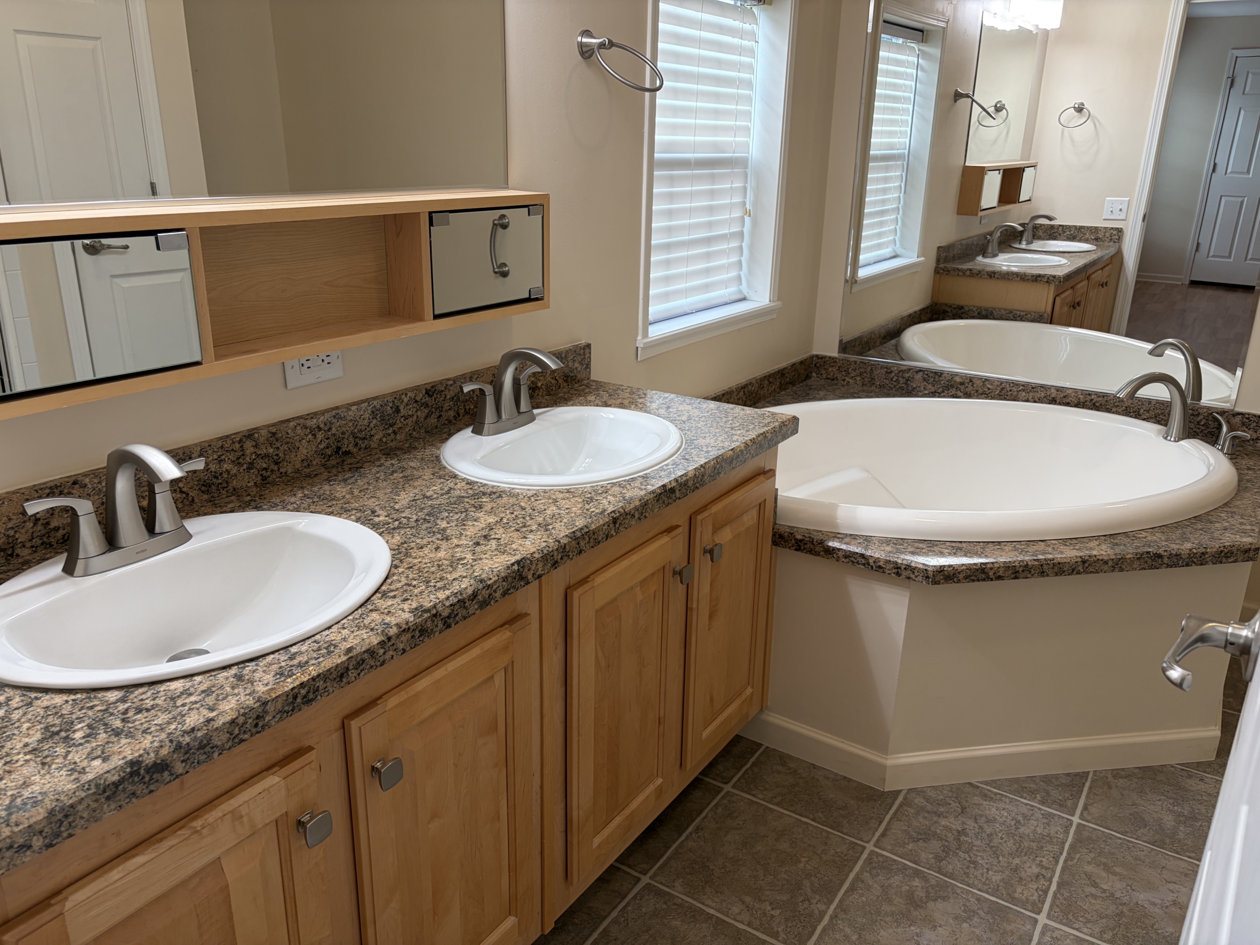 Master bathroom with double vanity and tub