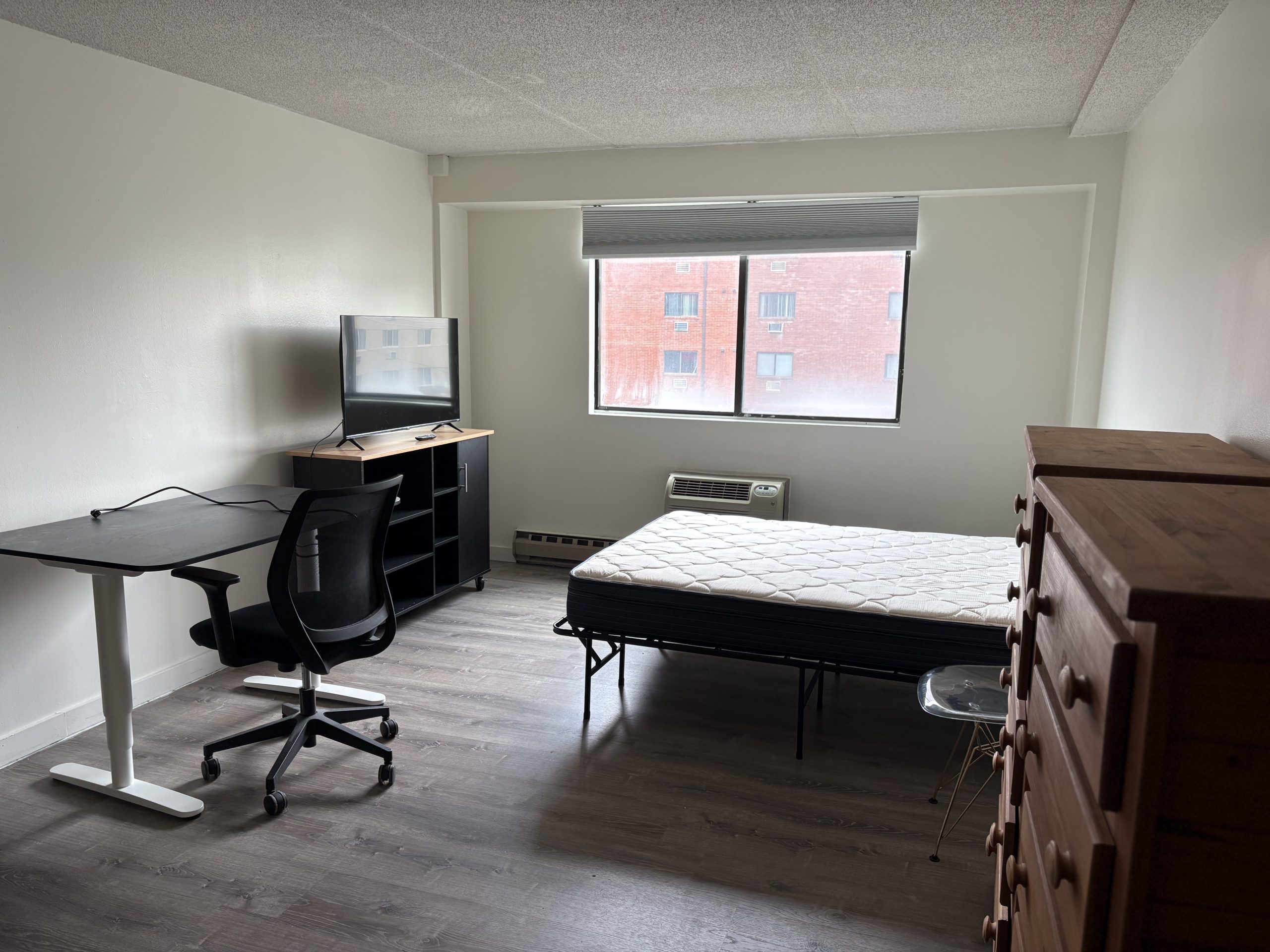 Hetzel Plaza Unit 409: Bedroom with bed, desk, dresser