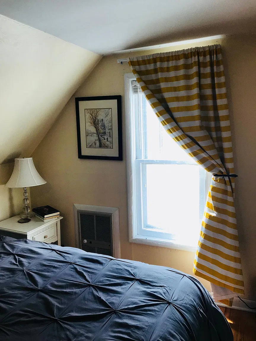 Bedroom with yellow striped curtains