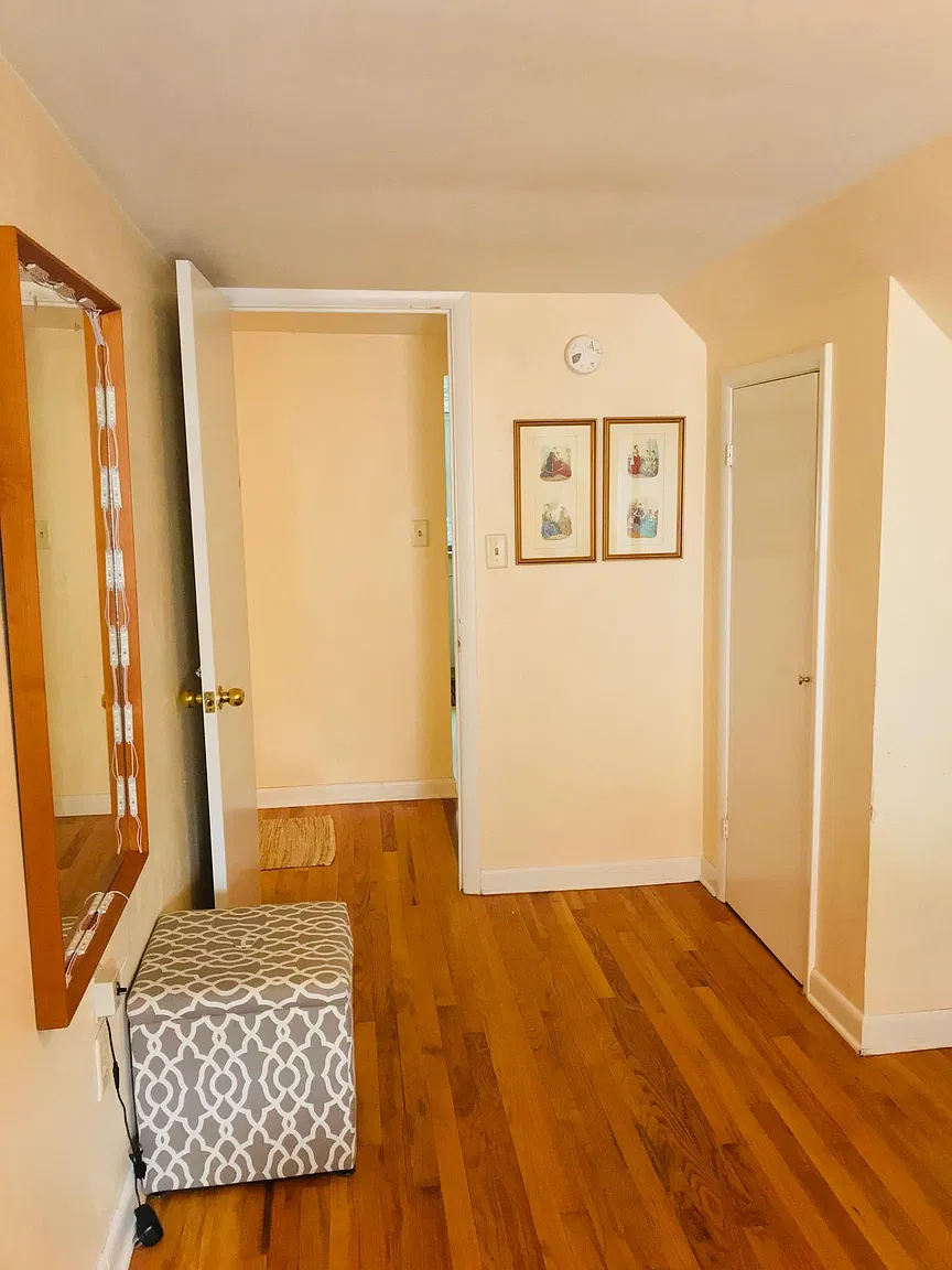 Hallway with mirror and two framed pictures